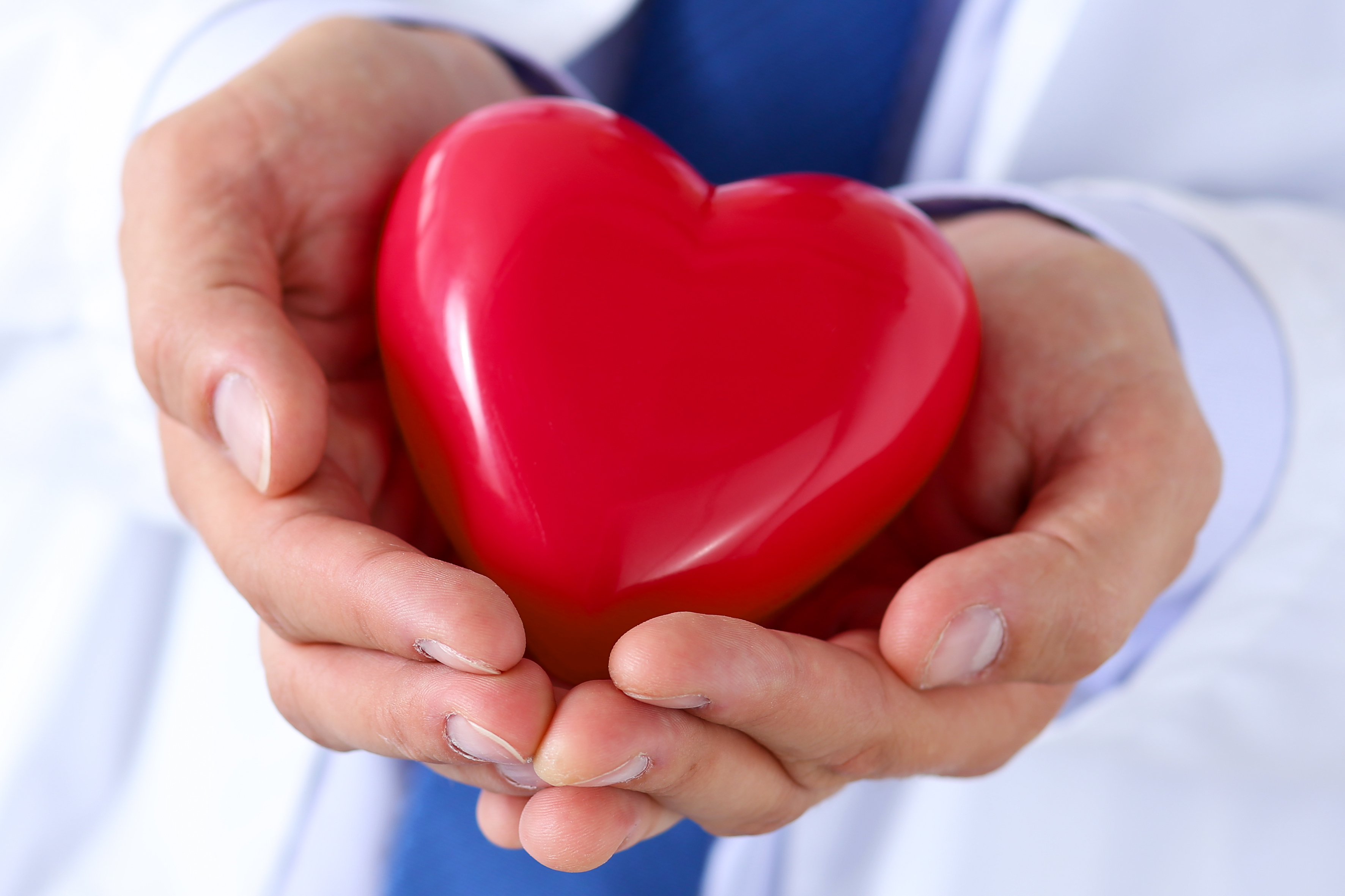 Podiatrist holding a heart in his hands.